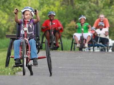 children riding adaptive bicycles