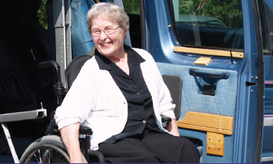 Woman in a wheelchair exiting van