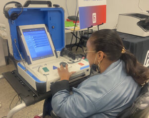 Agnes McCray, ARISE Board President testing a new voting machine.